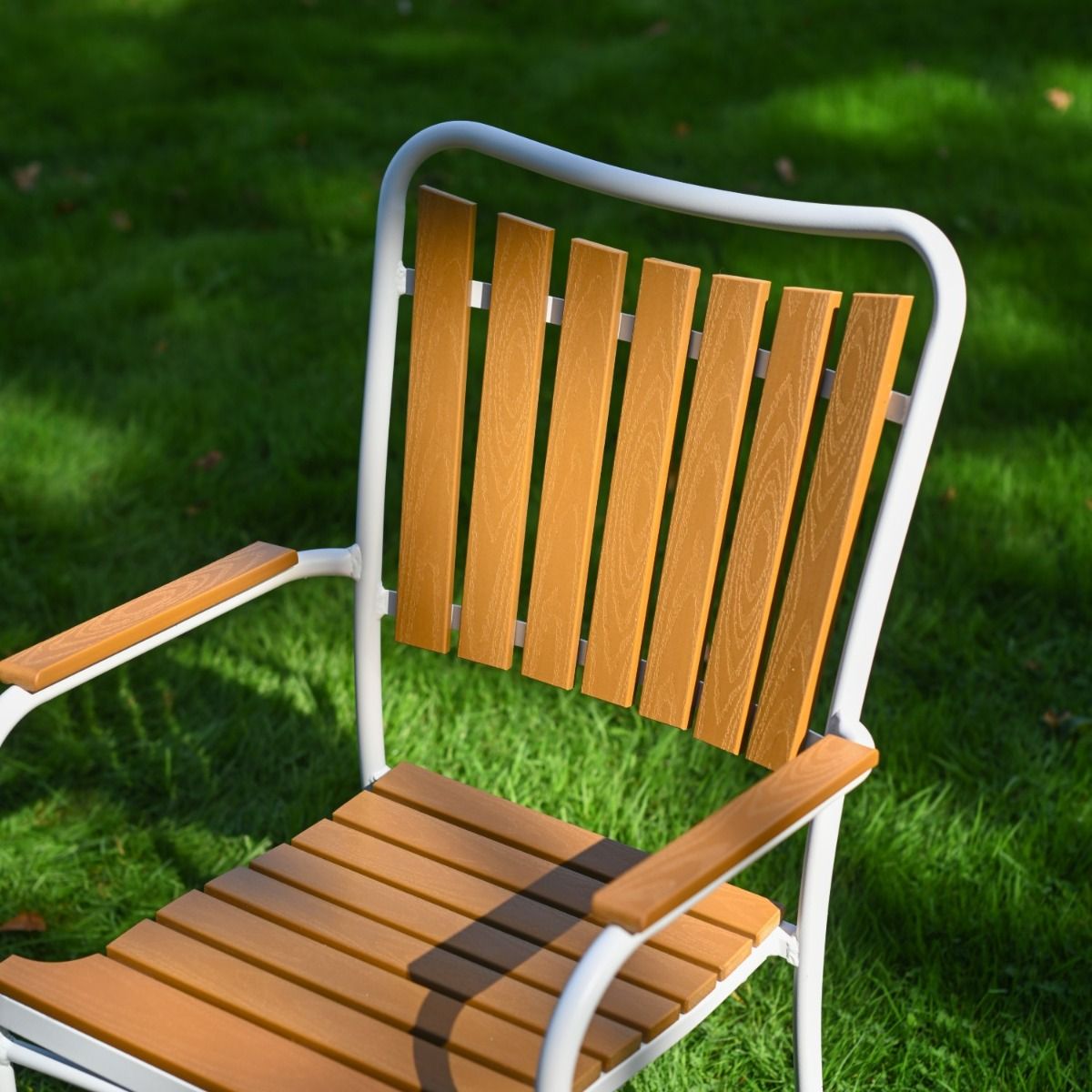 The Solis Round 4-Seater Outdoor Dining Set in White Showing the Arched Slatted Back Rest of a Chair
