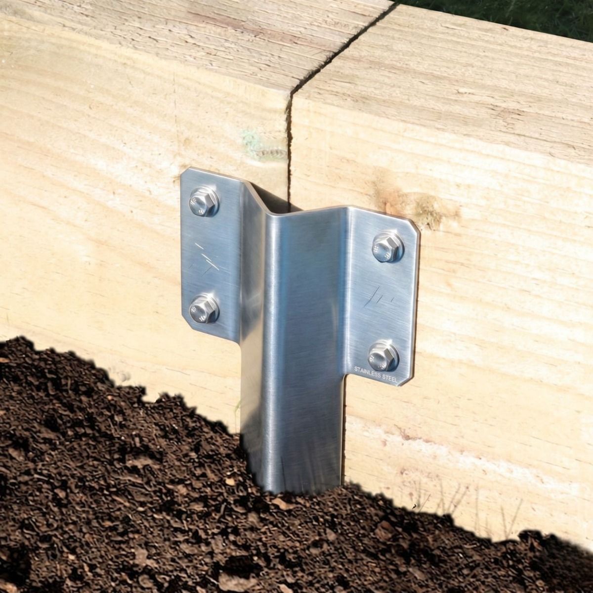 The Stainless Steel Railway Sleeper Straight Inline Spikes - Single in the Ground next to a Railway Sleeper Planter