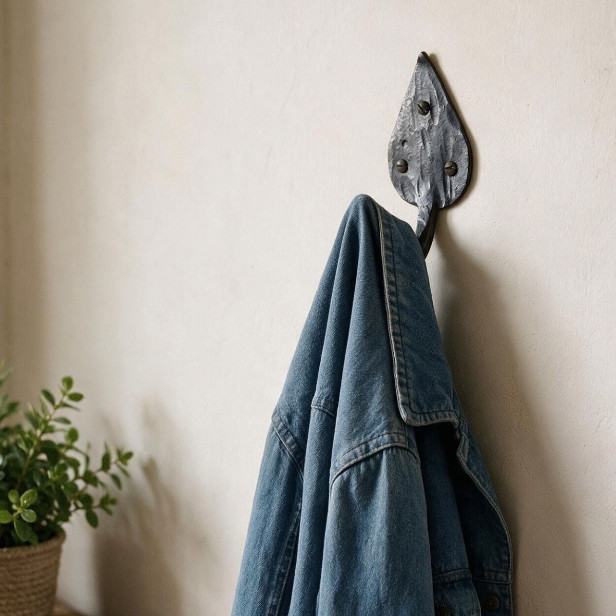 The Steel Leaf Shaped Hook Displayed with a Denim Jacket Hung on It - Digital Illustration 