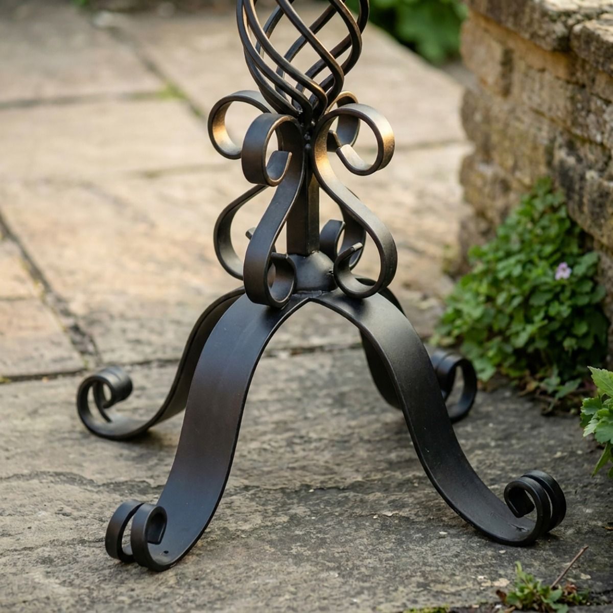 The "Stretton" Victorian Wrought Iron Basket Planter Stand in a Black Finish Looking Close up at the Base of the Planter - Digital Illustration 