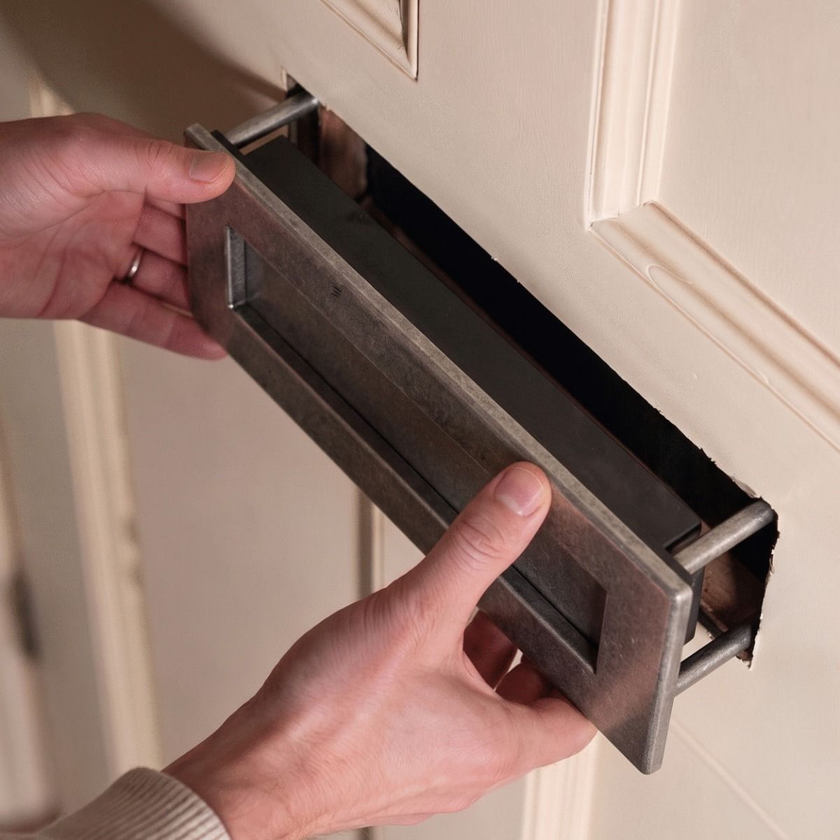The Traditional 12 Inch Front Door Letter Plate with Antique Period Style Flap in a Pewter Finish Shown being Installed - Digital Illustration 