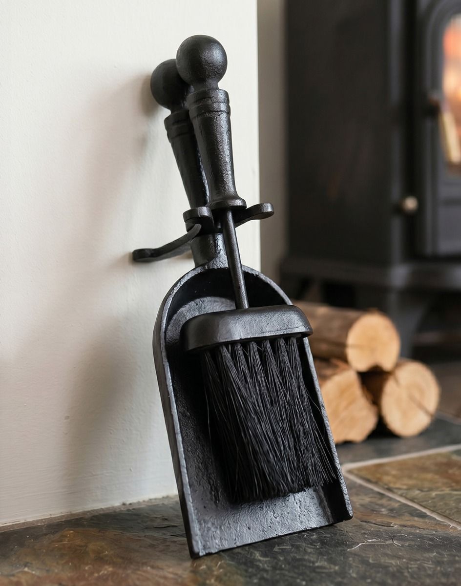 The Traditional Black Iron Pan & Brush Set on a Stone Tile Hearth next to a Log Burner Stove - Digital Illustration