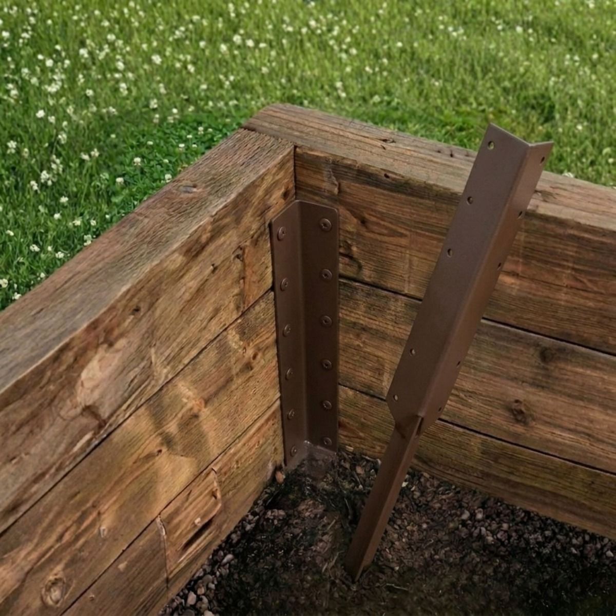 The Triple Brown Railway Sleeper Corner Spike on a Wooden Raised Garden Bed - Digital Illustration