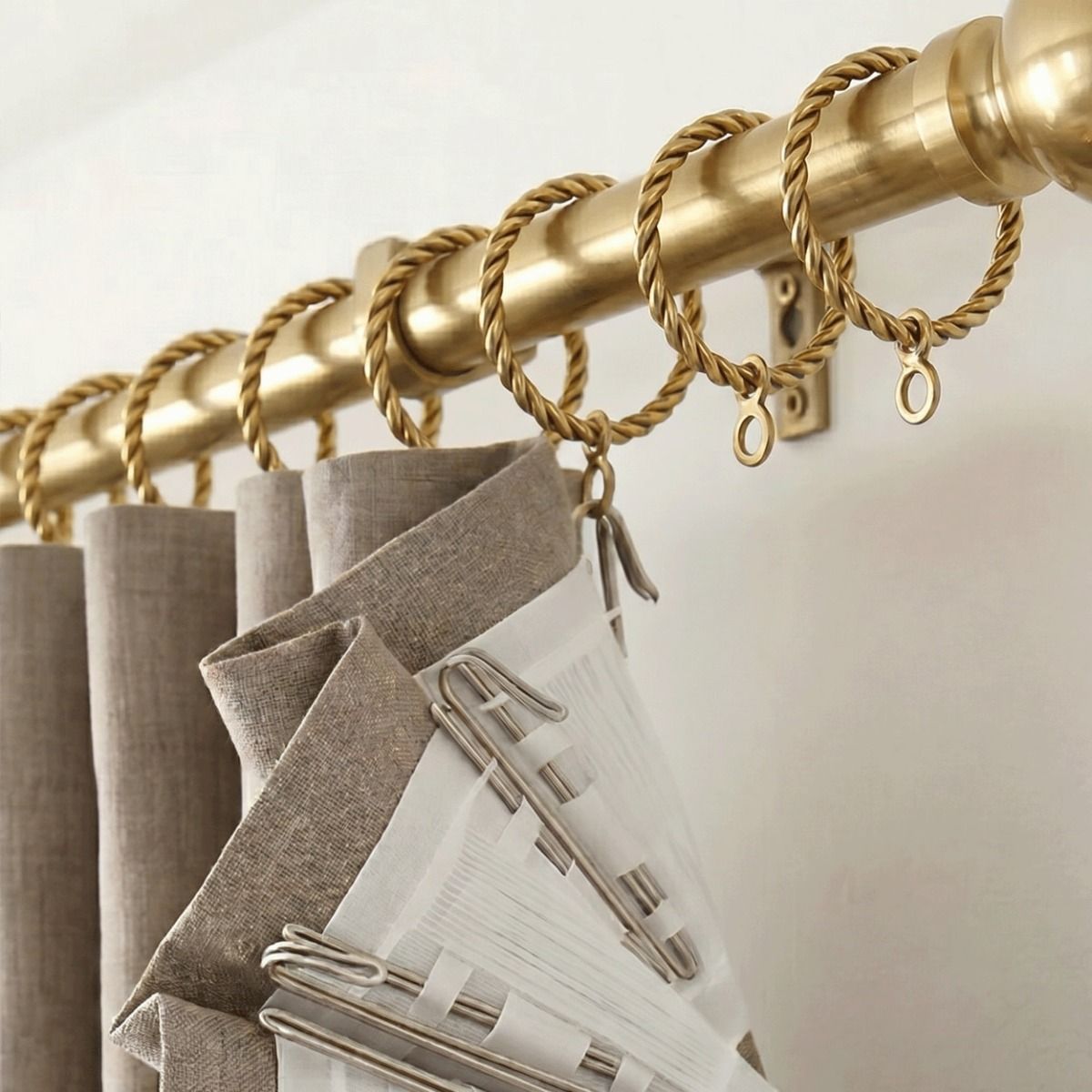 The Twisted Brass Curtain Rings in a Golden Coloured Finish Attached to a Matching Curtain Pole Supporting a Curtain - Digital Illustration 