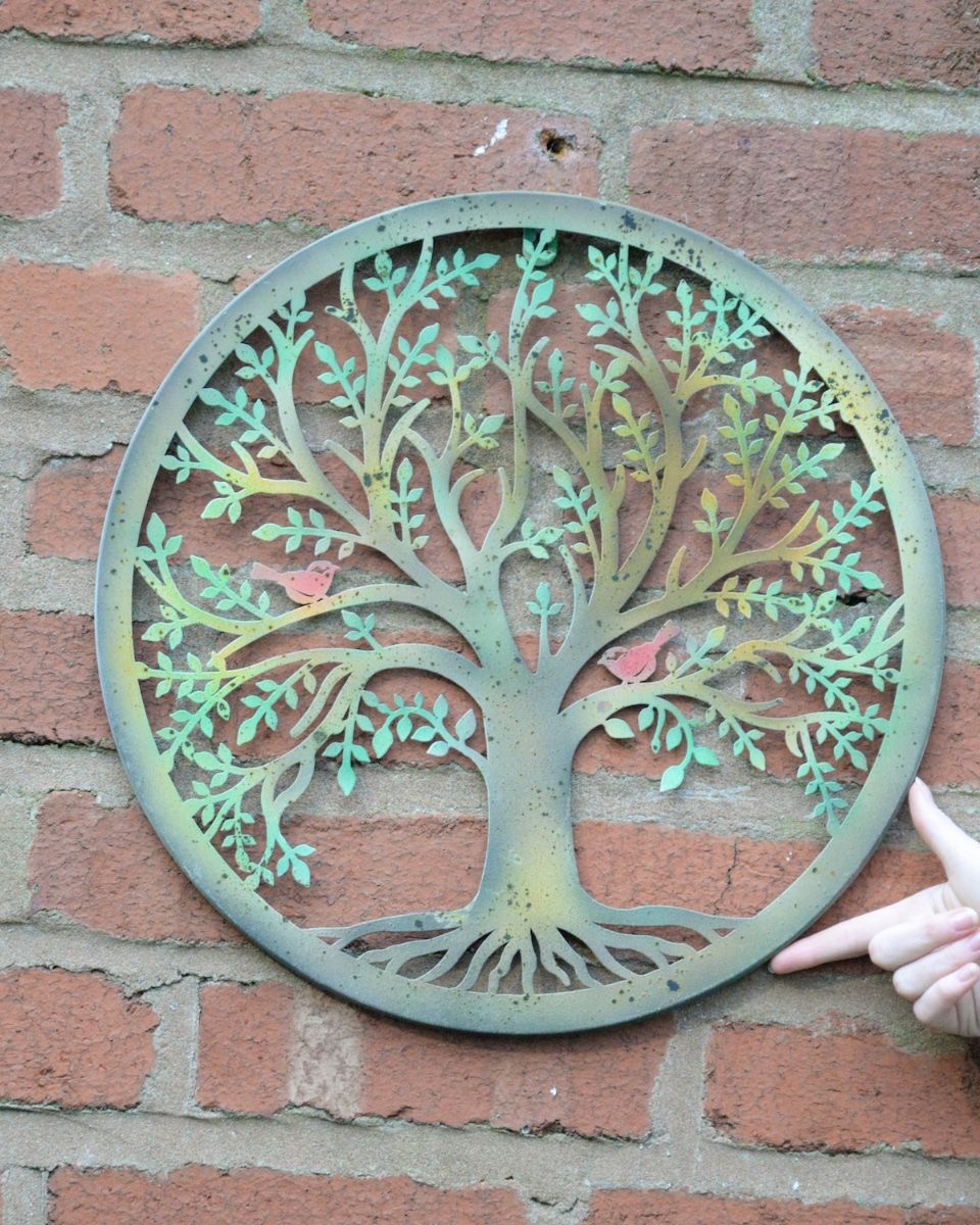 The Verdant Chorus Silhouette Garden Wall Art to scale with hand in shot