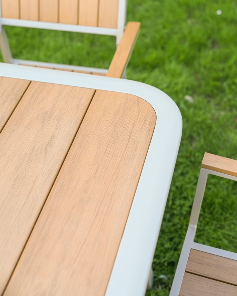 The Verve Quadrat 4 in Seater Outdoor Dining Set in Champagne Showing a Close up of One of the Rounded Corners of the Table
