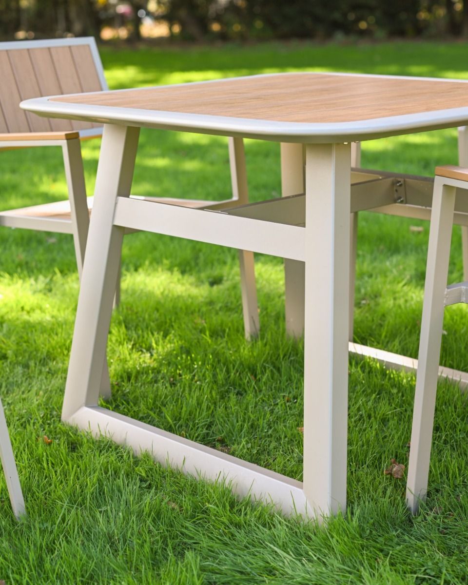 The Verve Quadrat 4 in Seater Outdoor Dining Set in Champagne Showing a Close up of the Legs of the Garden Furniture