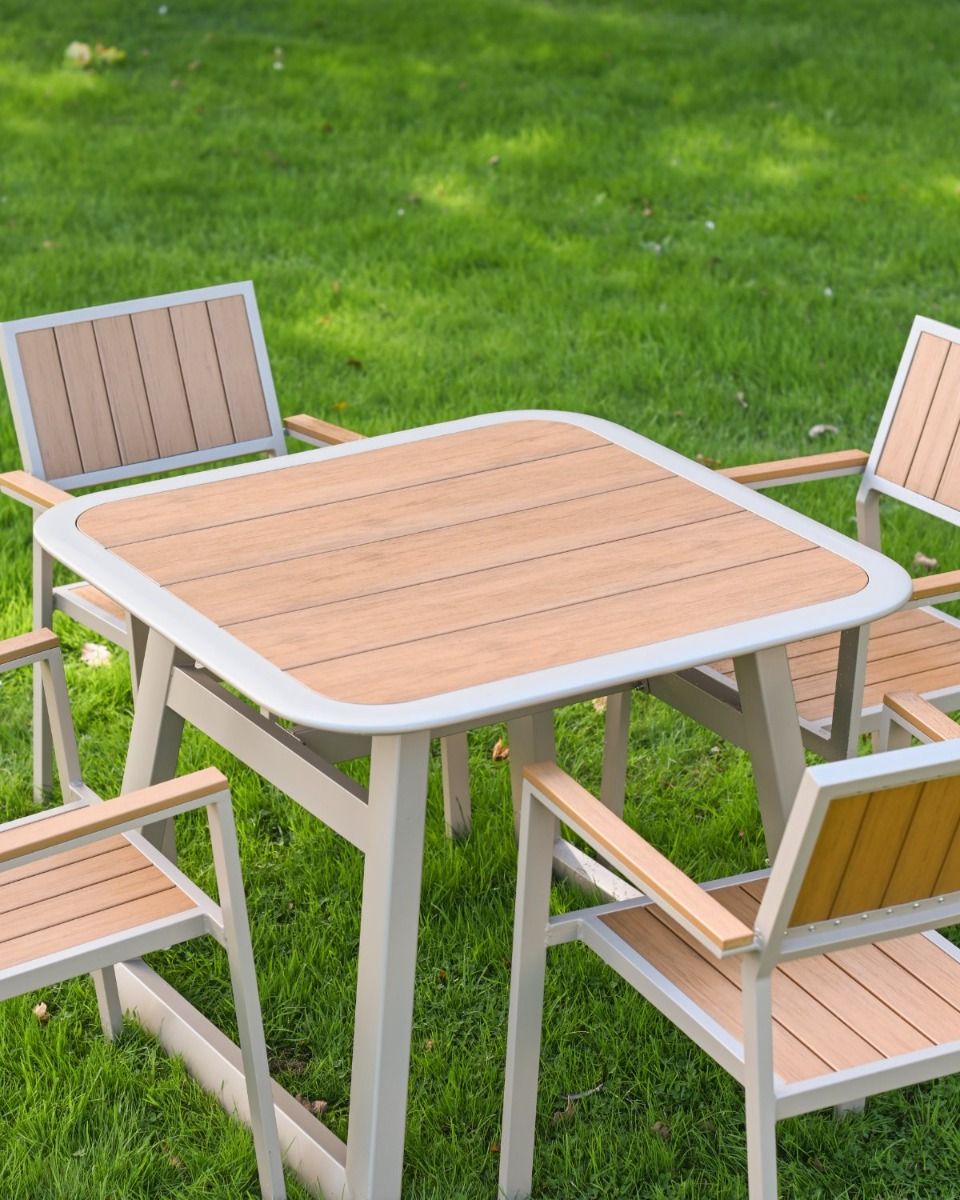 The Verve Quadrat 4 in Seater Outdoor Dining Set in Champagne Showing the Wood Effect Table Top Panelling
