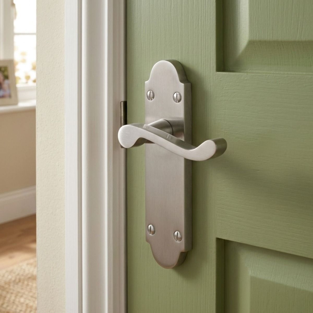 The Victorian Scroll Latch Arched Door Handle in Polished Chrome on an Olive Green Door in a Family Home - Digital Illustration