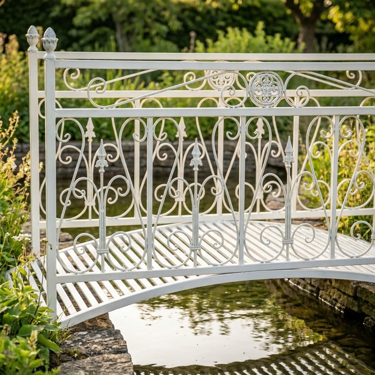 The Westminster Victorian Ornate Wrought Iron Garden Bridge in a White Finish Shown in a Sunny Private Garden over a Small Stream Focussing on the Left Side - Digital Illustration 
