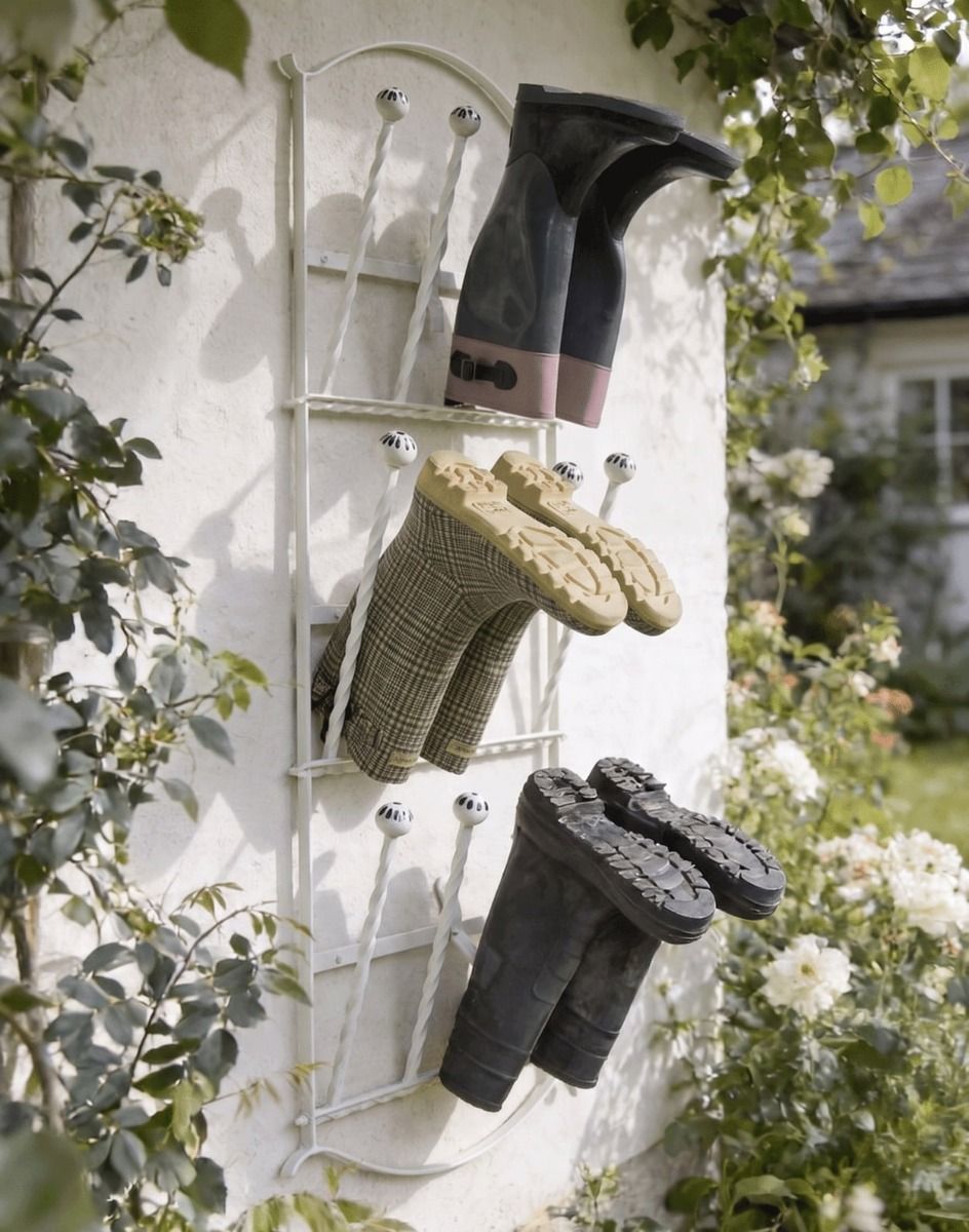 The Winsbury Cream Wall Mounted 6 Pair Boot Rack Fixed to a Sunny Garden Exterior Wall - Digital Illustration 