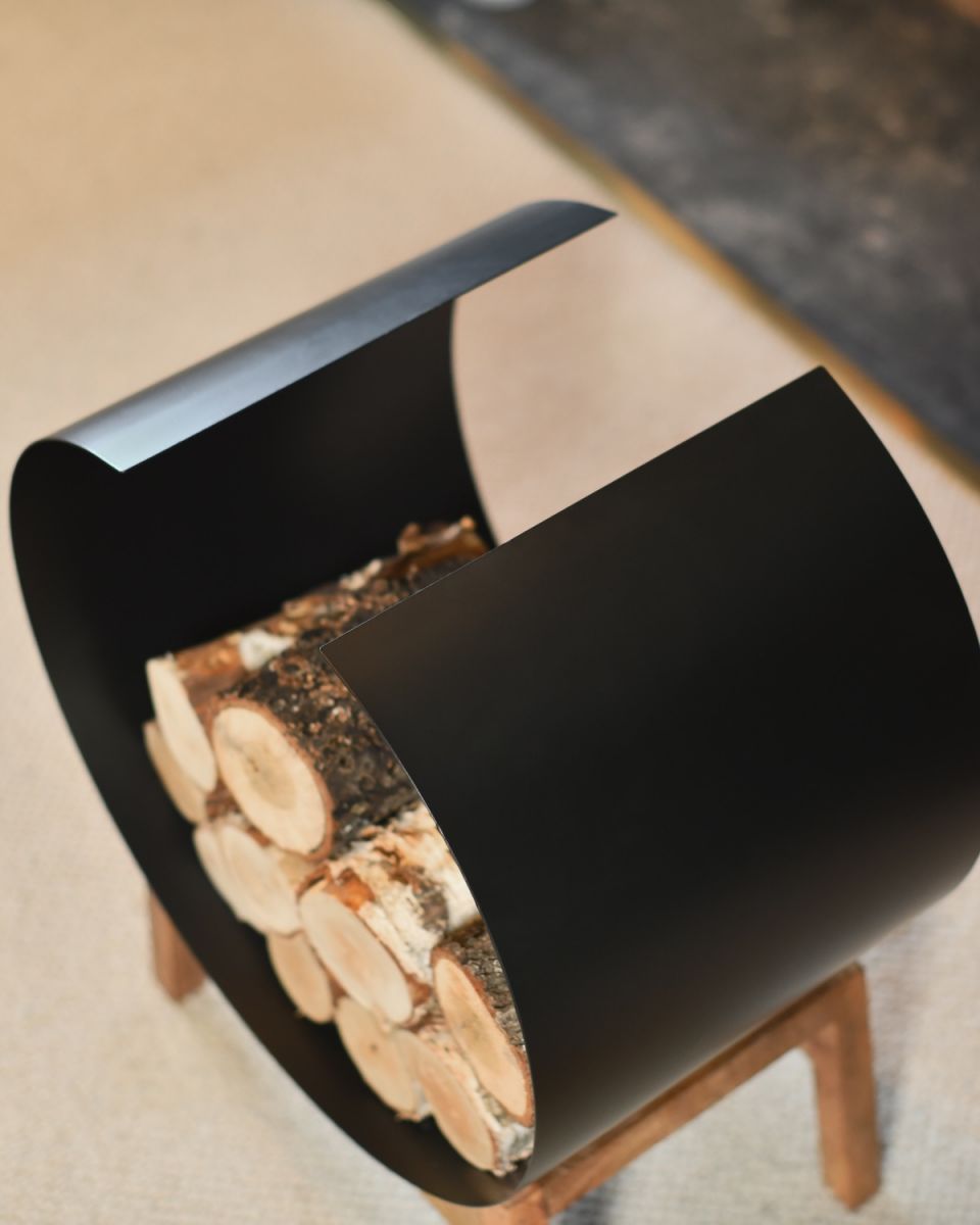 Close up of curved steel detail on fireside log rack