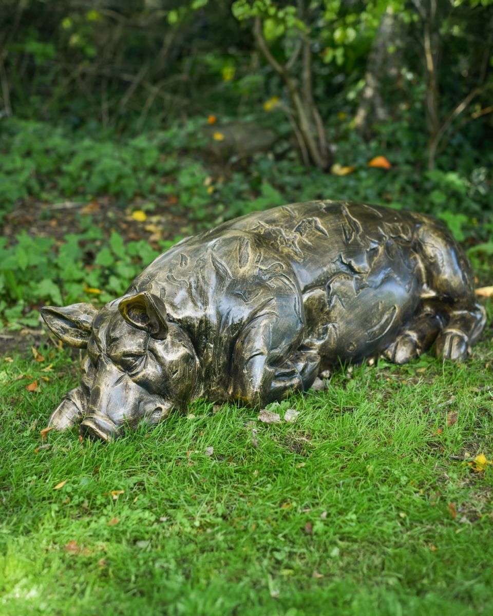 In situ photo of sleeping pig garden sculpture