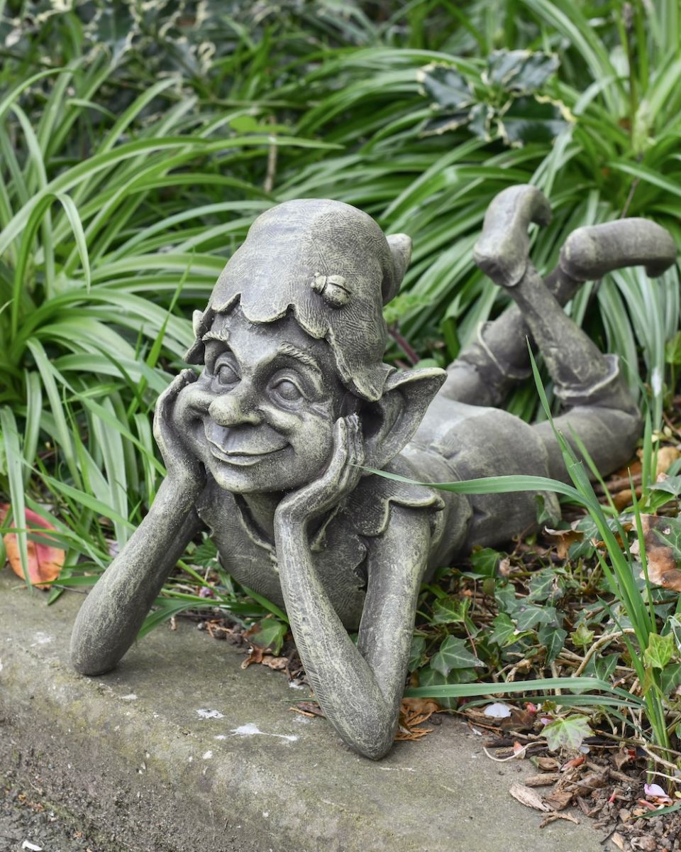 Angled view of daydreaming pixie garden statue