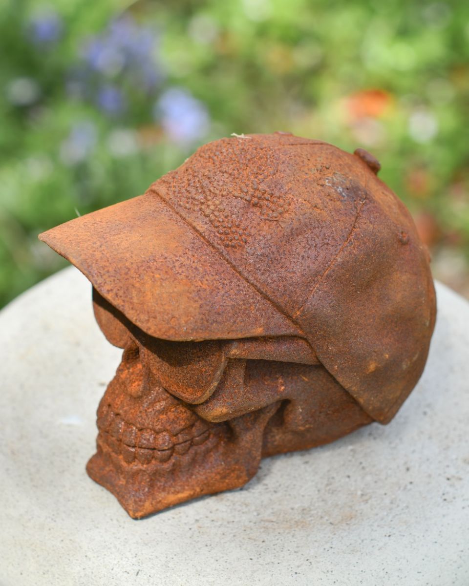 Close up of hat detail on rustic finish garden statue