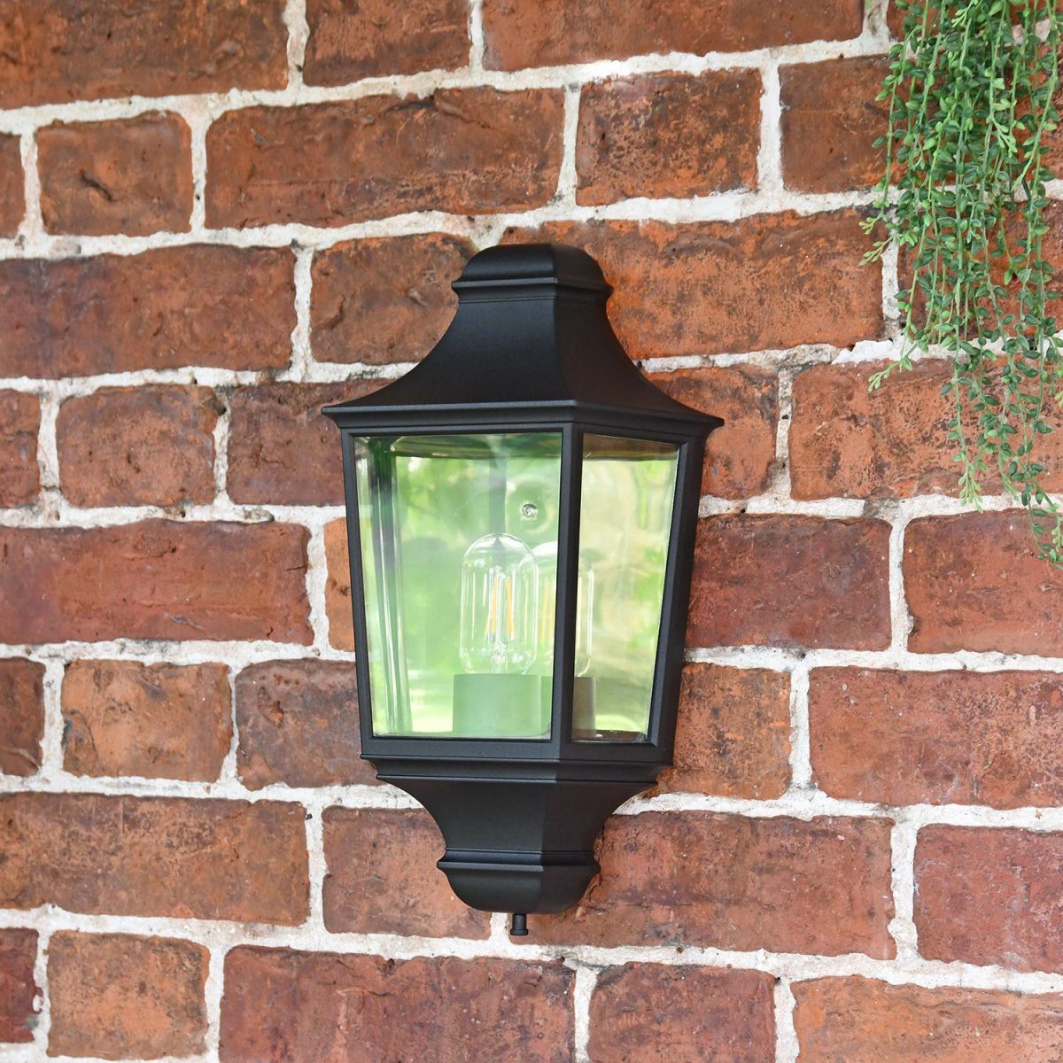 Front View of the "Traditional Black Flush Half Wall Lantern on a Brick Wall