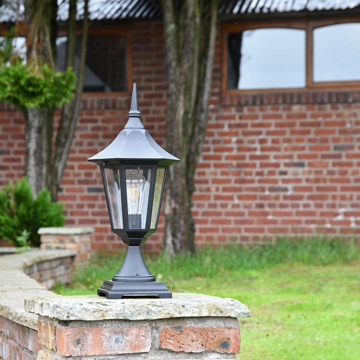 Traditional Black Tinted Pillar Light on a Brick Wall
