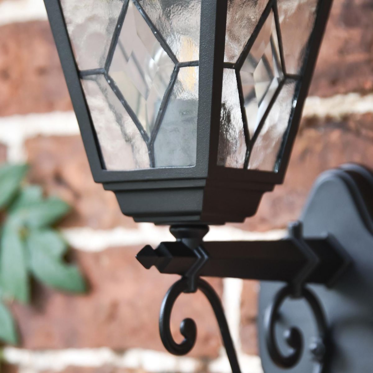 Close-up of Traditional Black Victorian Outdoor Wall Lantern with Ornate Bracket