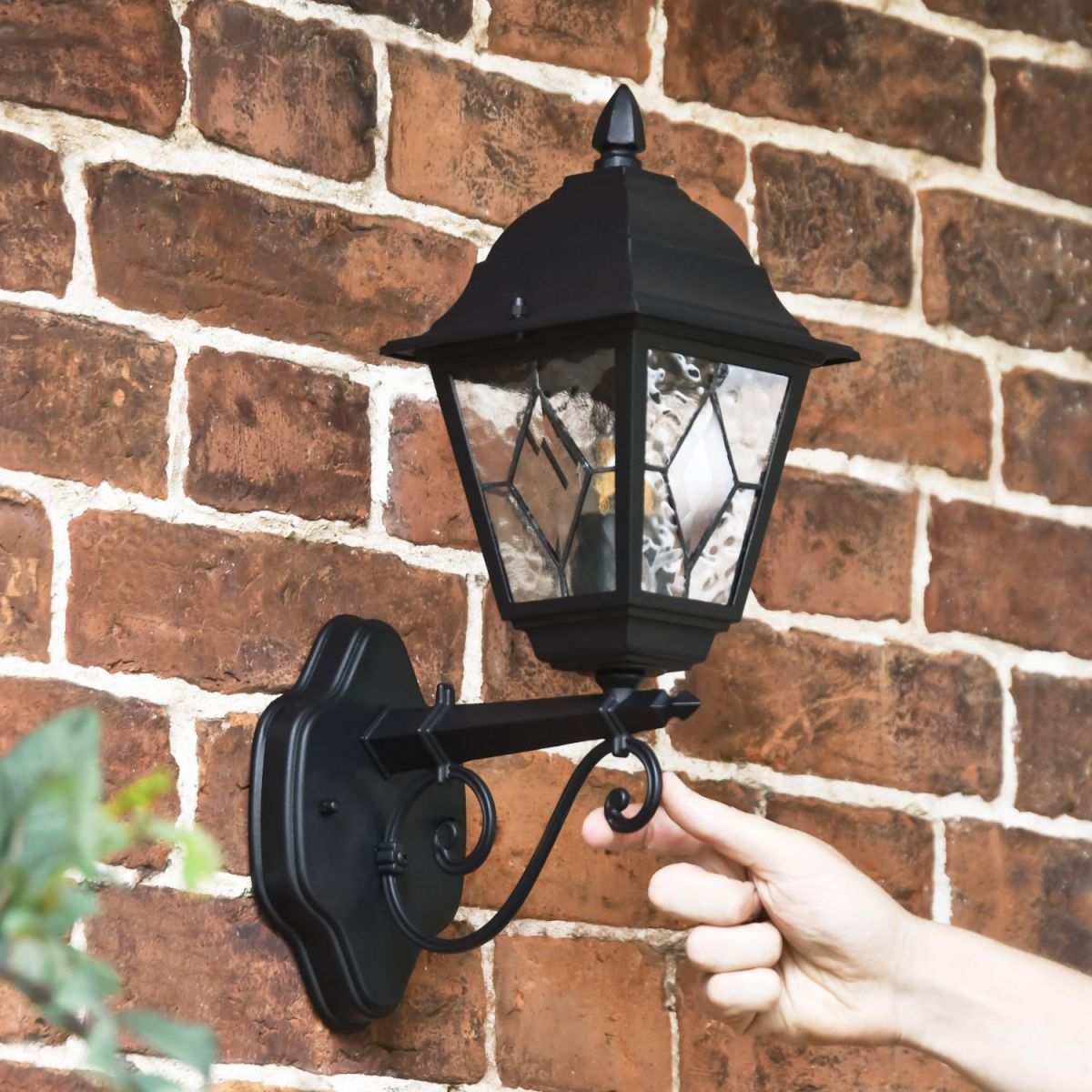 Scale Shot of Traditional Black Victorian Outdoor Wall Lantern with Ornate Bracket