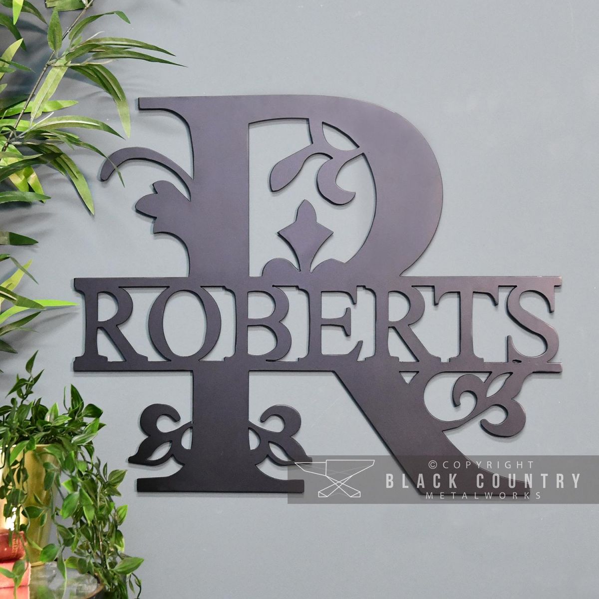 Monogram Sign in Situ on a Blue Wall