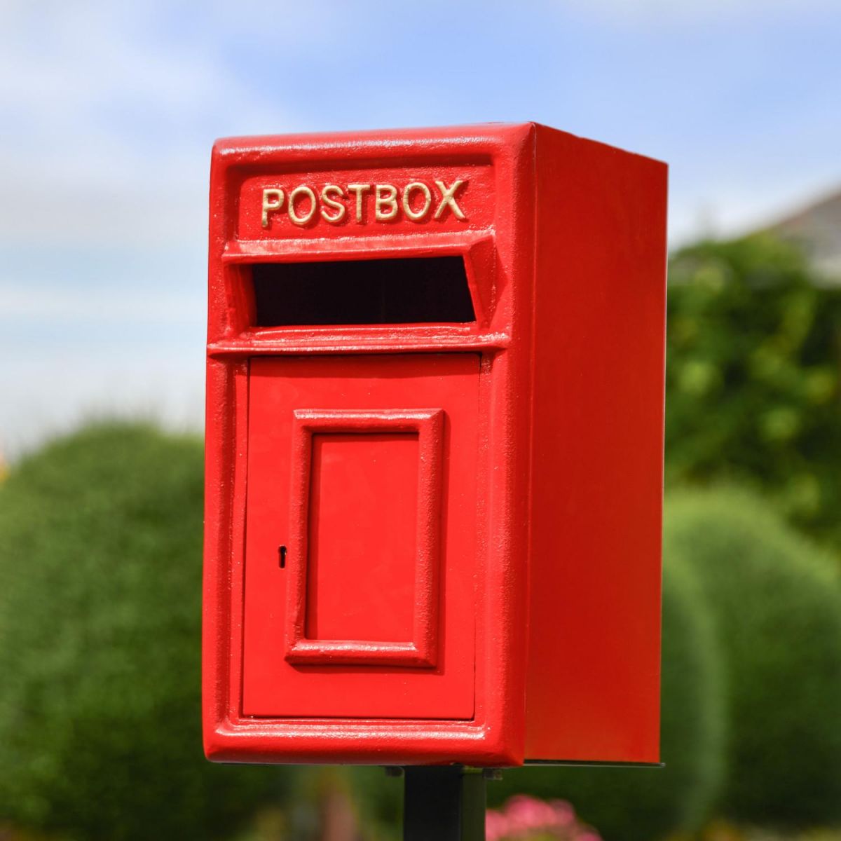 Close-Up of Traditional Red & Gold Post Box and Stand