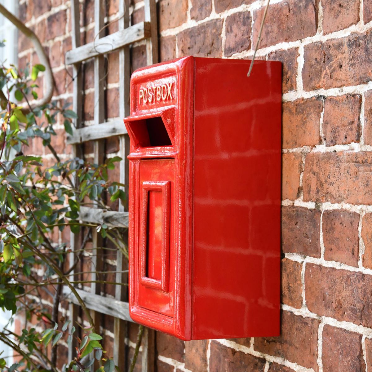 Traditional Red & Gold Wall Mounted Post Box Mounted on a Brick Wall