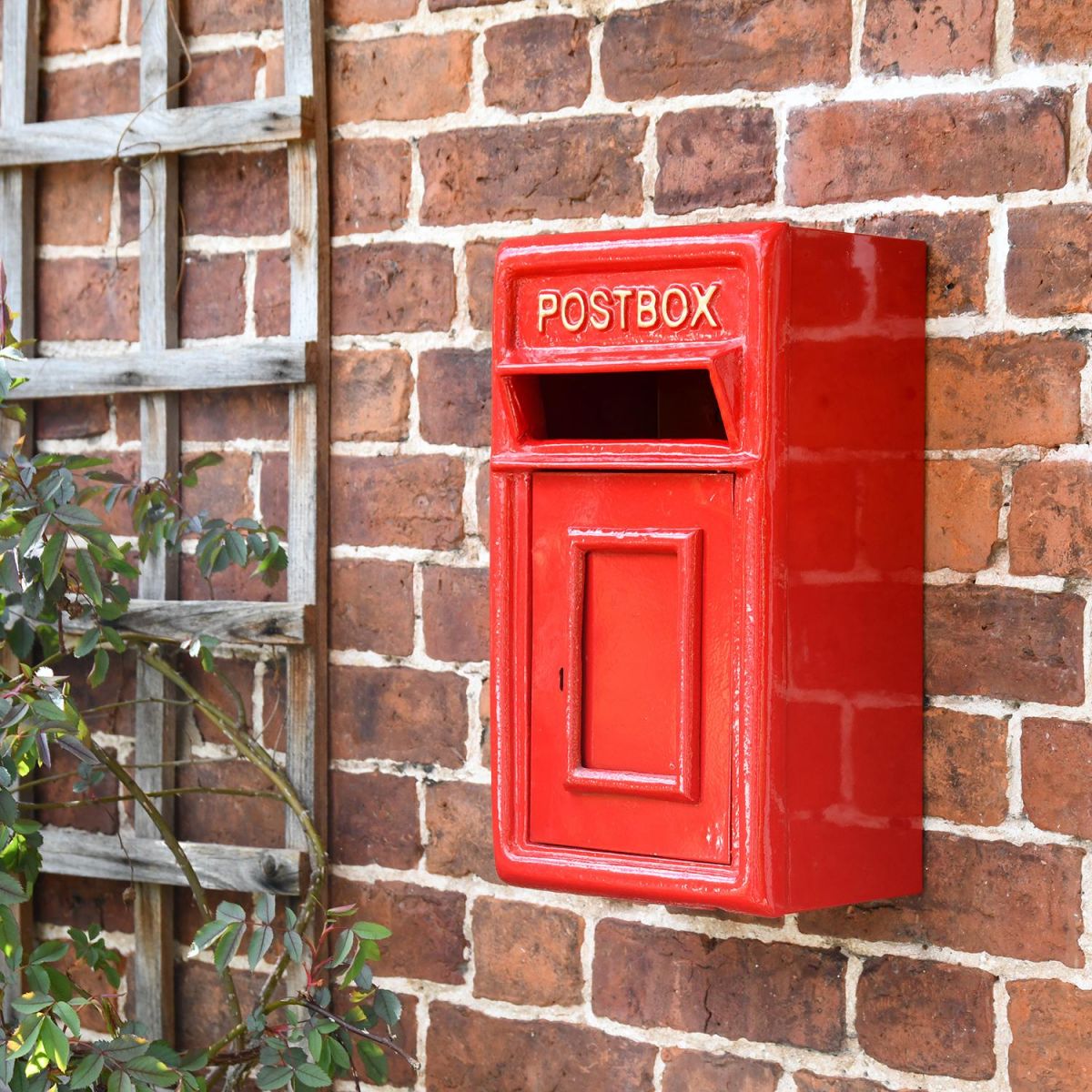 Traditional Red & Gold Wall Mounted Post Box on the Front of a House