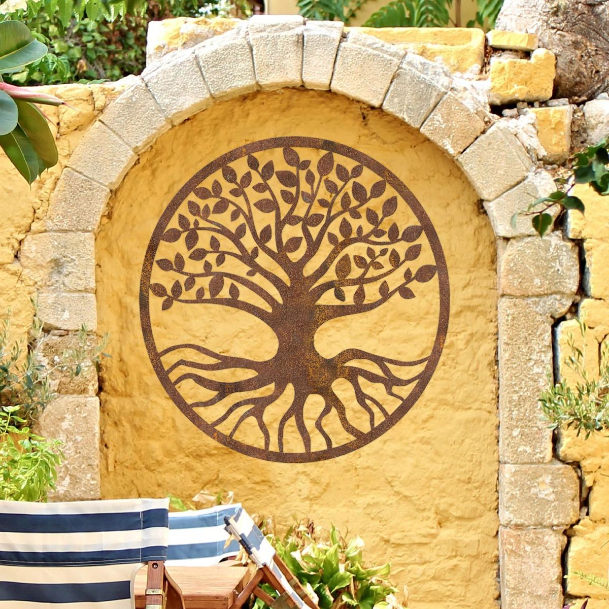 Rustic Round "Tree of Life" Wall Art on a Yellow Garden Wall