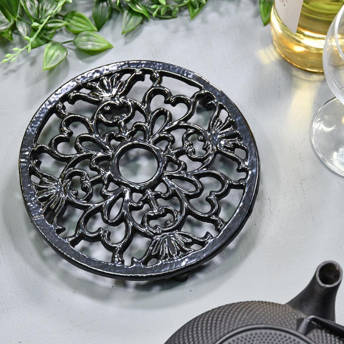 Heavy Duty Cast Iron Round Trivet Being Used on a Dining Room Table