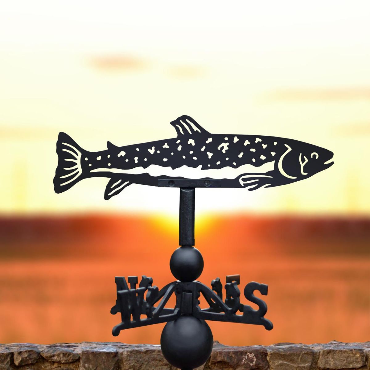 Trout fish weathervane in the sunset