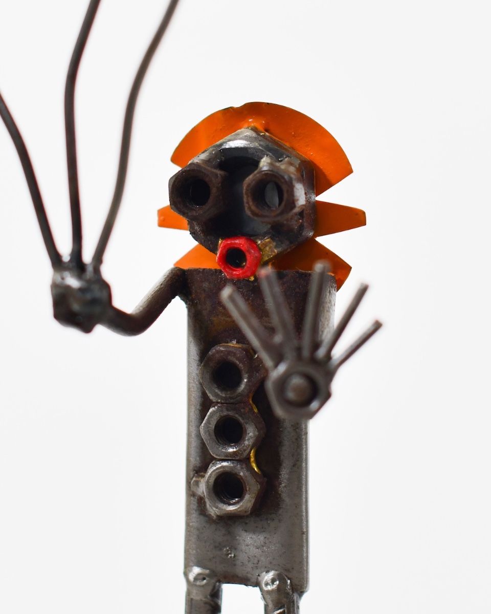 Tuppence the Clown Upcycled Metal Ornament close up of head made from recycled nuts