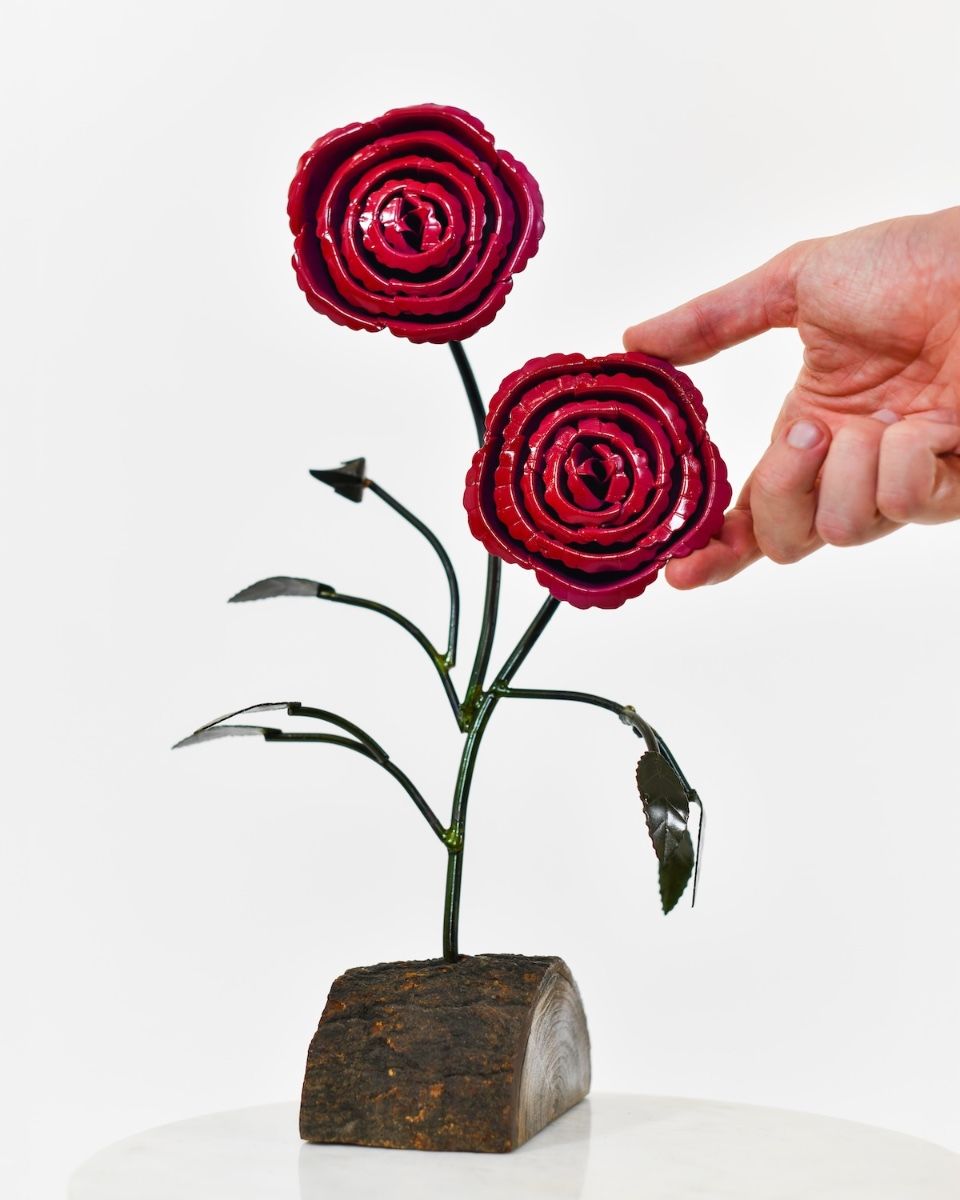 Twin bloom Upcycled Steel Botanical Sculpture in Wooden Base - Red with hand in shot for scale