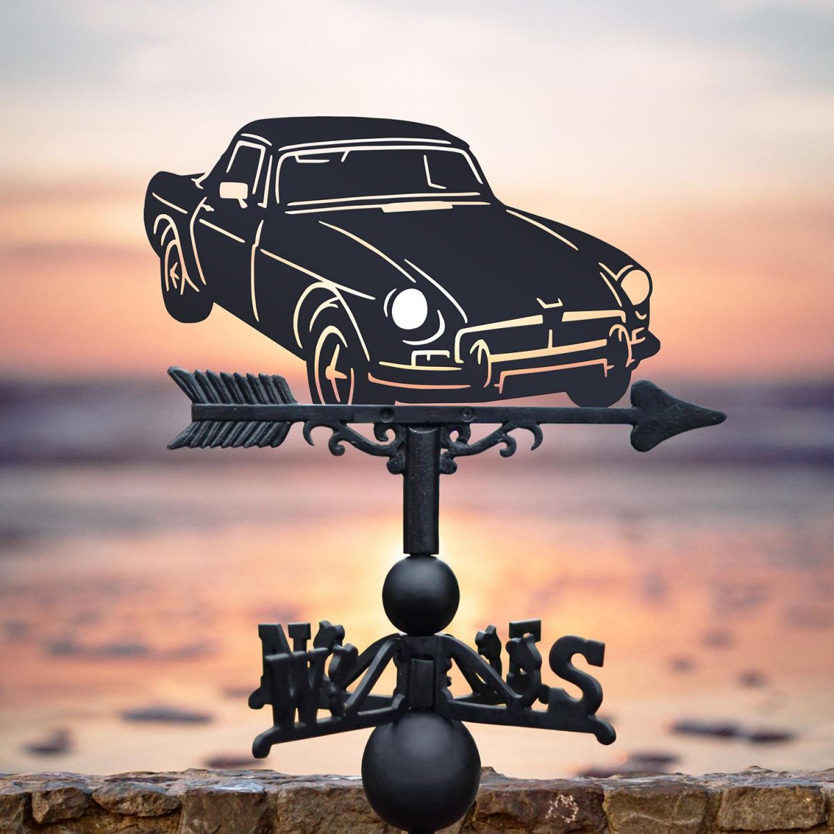 Black MGB Roadster Weathervane on beach background