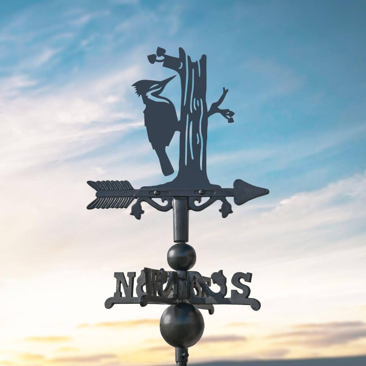 Woodpecker on Miniature Weathervane at Dusk Woodpecker on Miniature Weathervane at Dusk