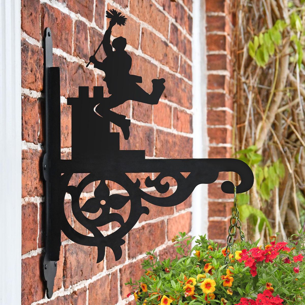 Ornate Chimney Sweep Hanging Basket Bracket Mounted on a Brick wall Ornate Chimney Sweep Hanging Basket Bracket Mounted on a Brick wall