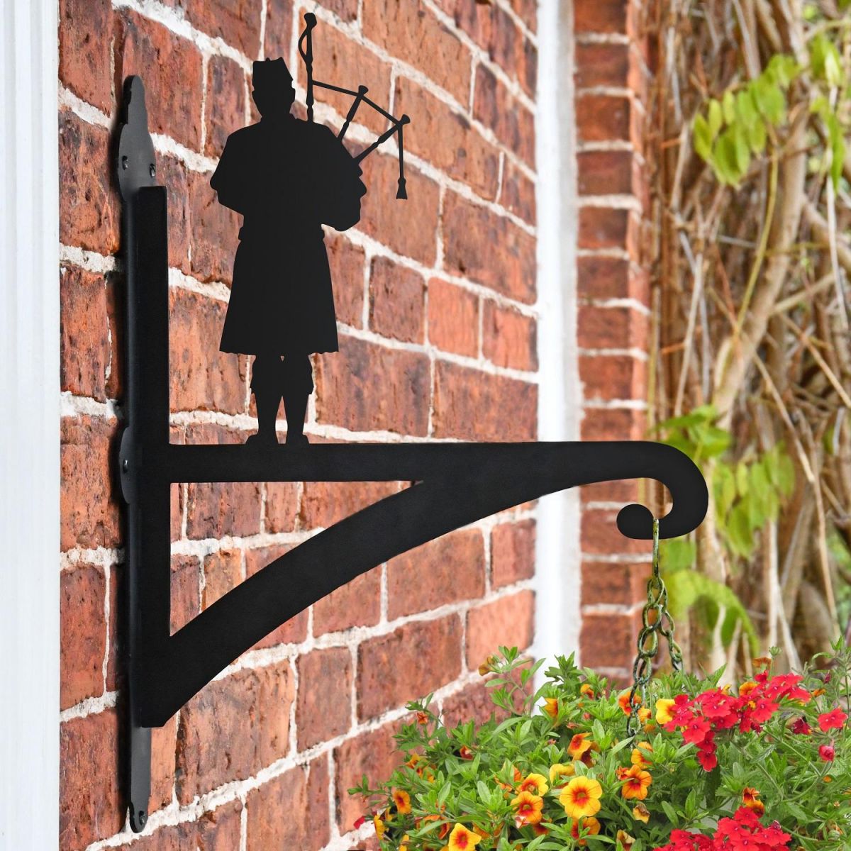 Scottish Bagpiper Hanging Basket Bracket Mounted onto a Brick Wall  Scottish Bagpiper Hanging Basket Bracket Mounted onto a Brick Wall