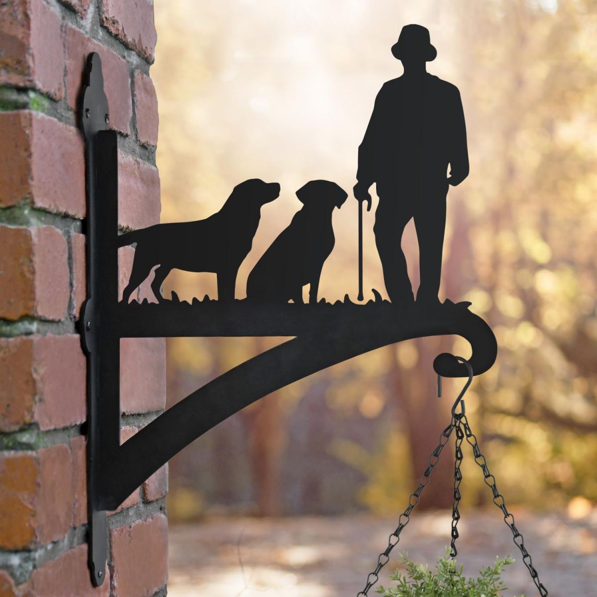 Man with Walking Stick and Two Labs Hanging Basket Bracket at Sunset
