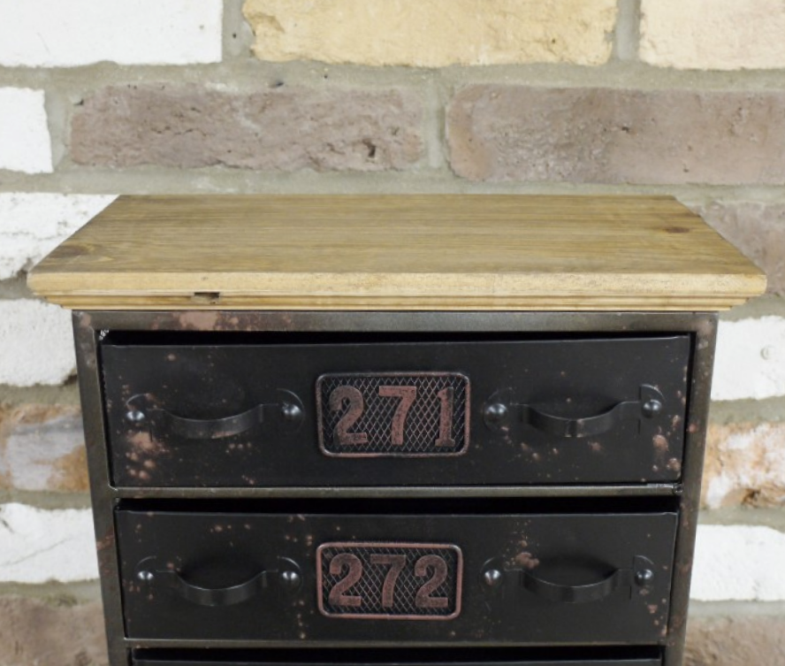 Close up of metal drawers & wooden table top Close up of metal drawers & wooden table top
