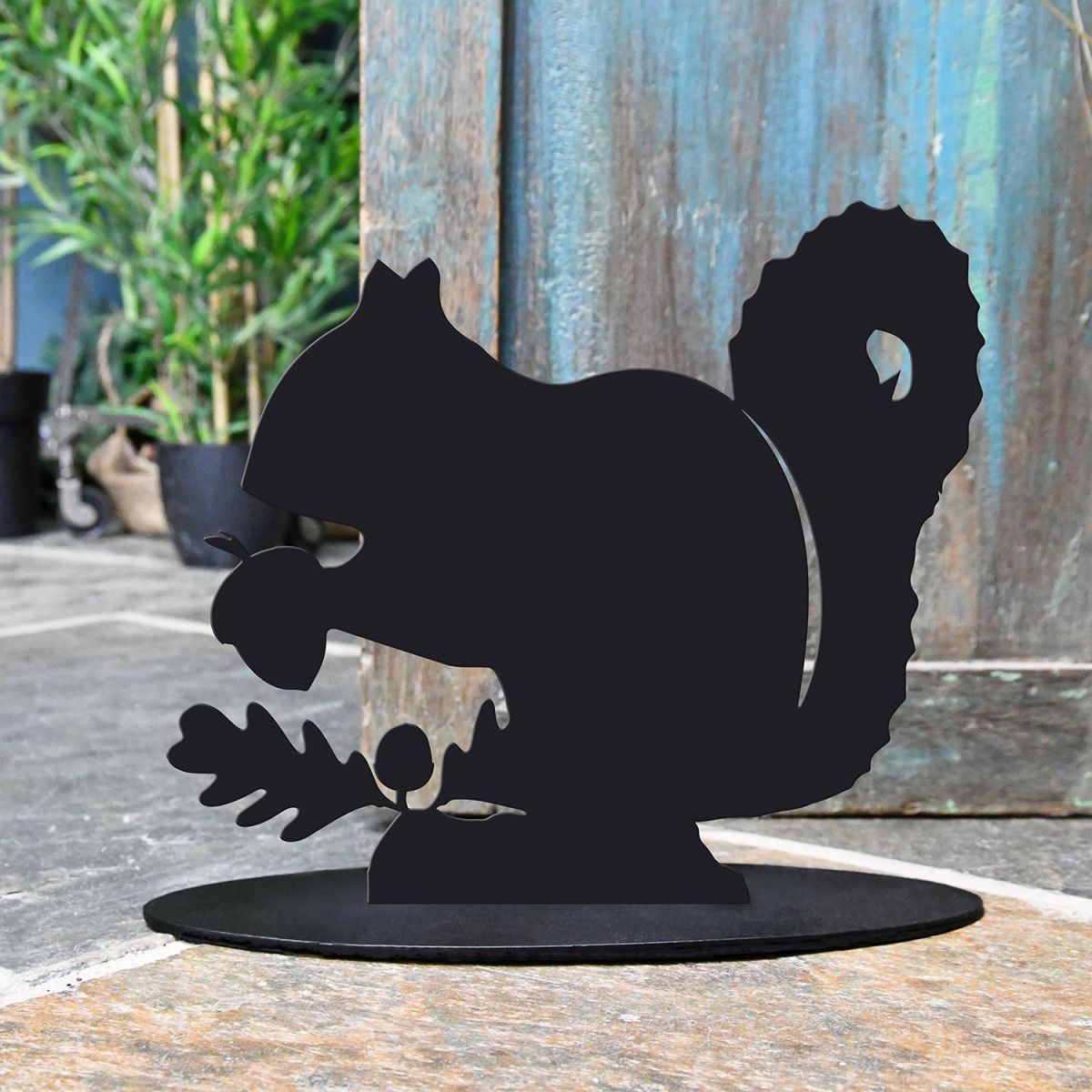 Squirrel Iron Door Stop Next to a Rustic Blue Door