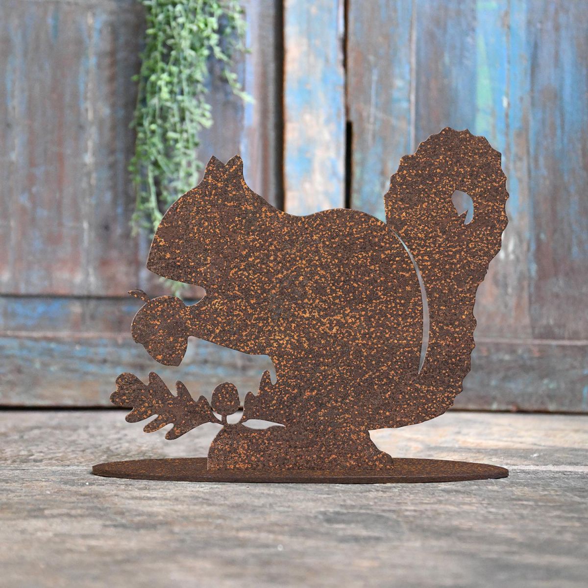 Squirrel Rustic Iron Door Stop in Front of a Rustic Blue Door