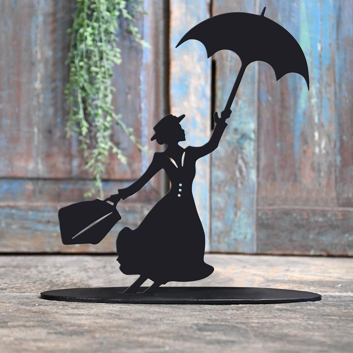 Mary Poppins Iron Door Stop Next to a Rustic Blue Door Mary Poppins Iron Door Stop Next to a Rustic Blue Door