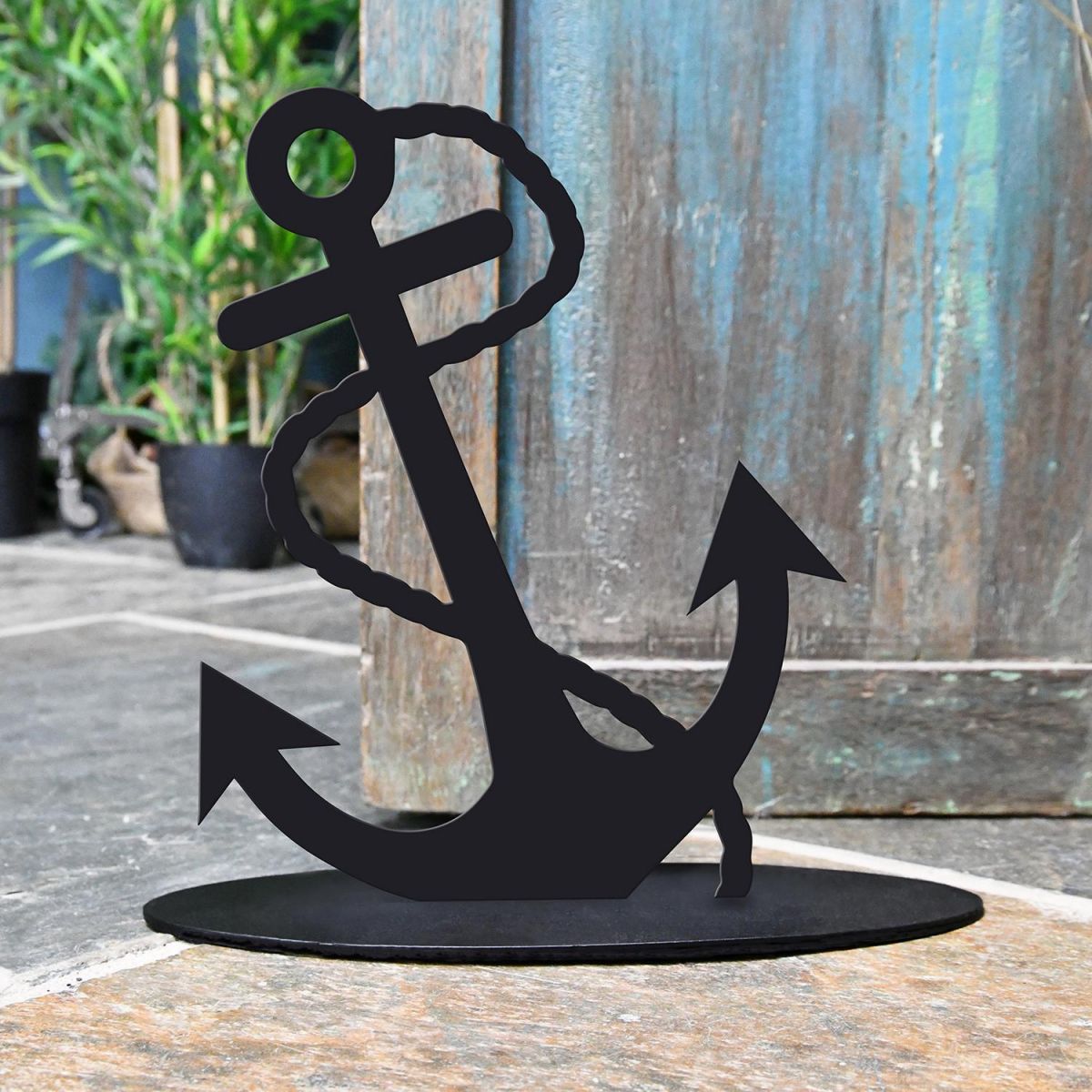 Anchor Iron Door Stop Next to a Rustic Blue Door