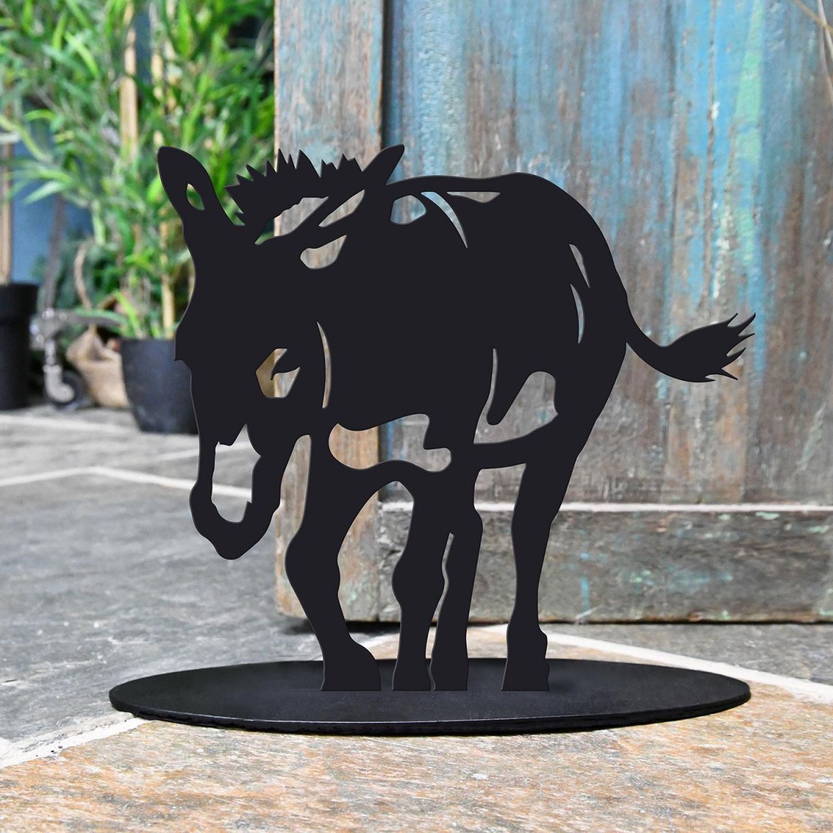 Donkey Iron Door Stop Next to a Rustic Blue Door