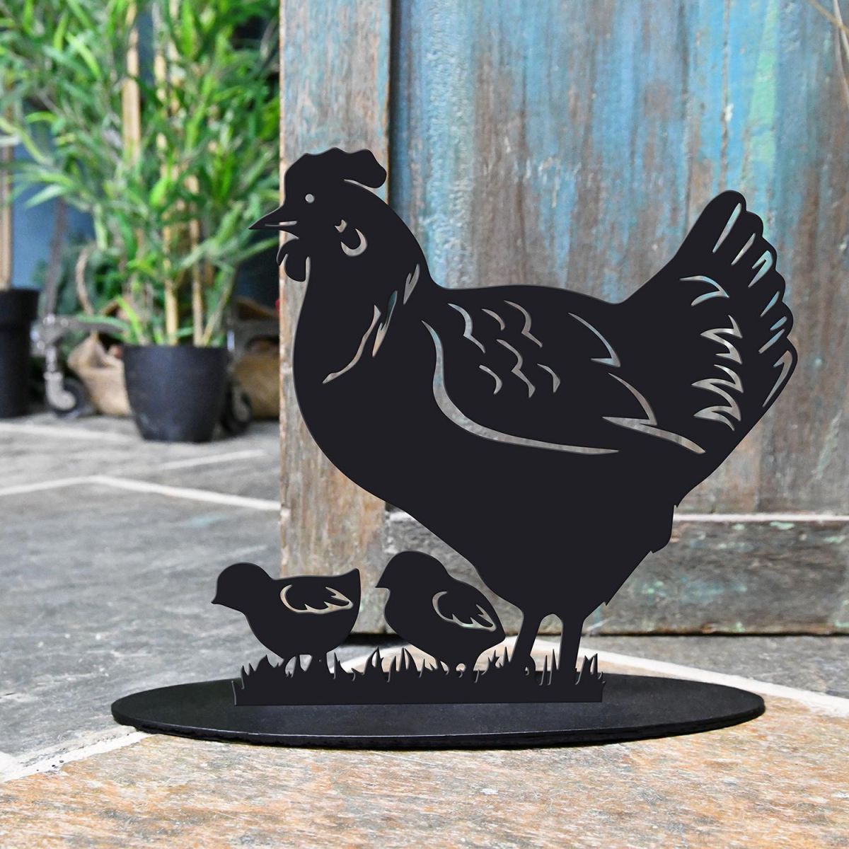 Hen & Chicks Iron Door Stop Next to a Rustic Blue Door