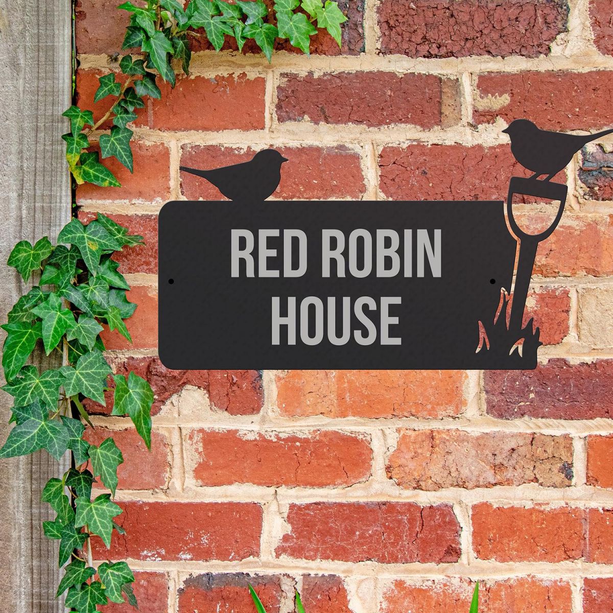 Robin Iron House Name Sign Mounted o a Brick Wall