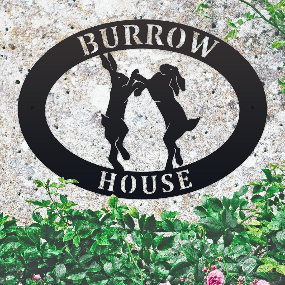 Boxing Hares Iron Oval House Sign on a Stone Wall