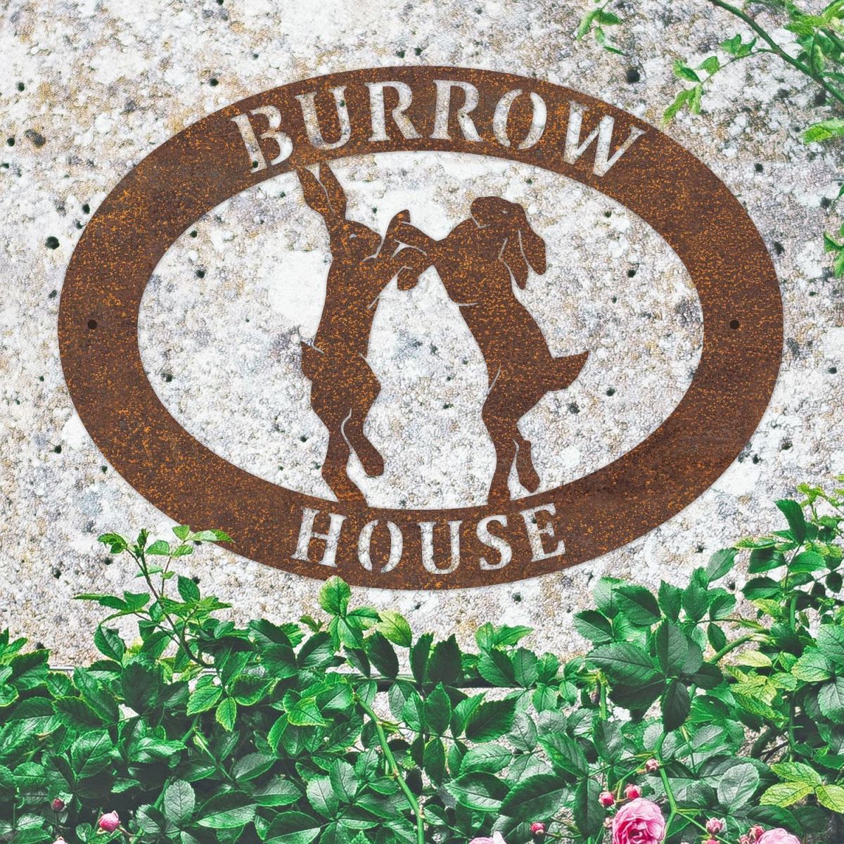 Boxing Hares Iron Oval House Sign on a Stone Wall