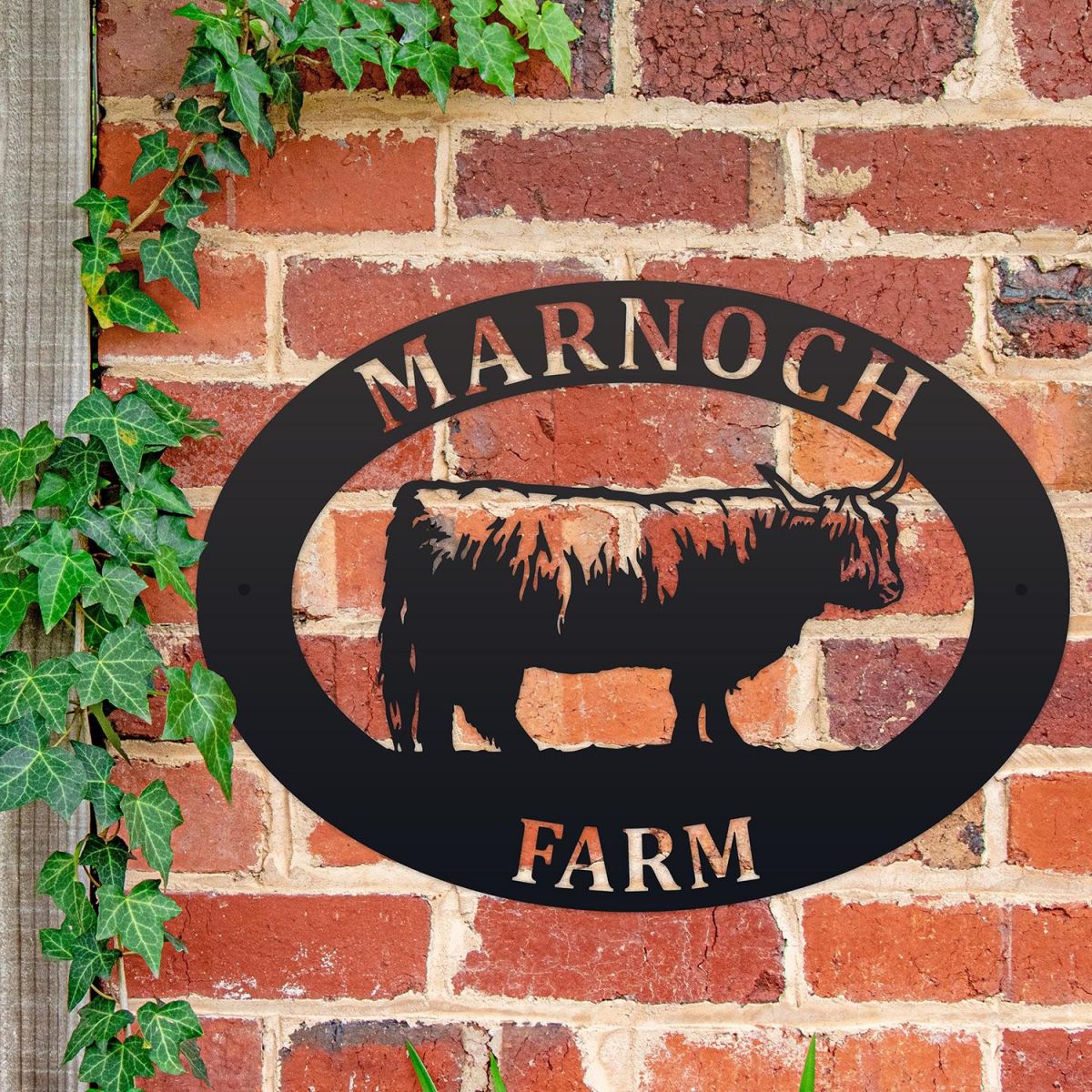 Highland Cow Iron Oval House Sign on a Brick Wall