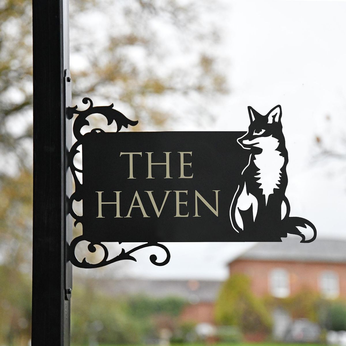 Sitting Fox Iron Bracket Name Sign in Situ on a Sign Post