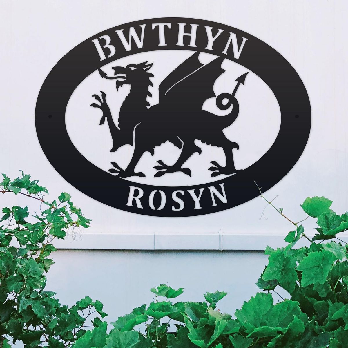 Welsh Dragon Iron Oval House Sign on a White Wall